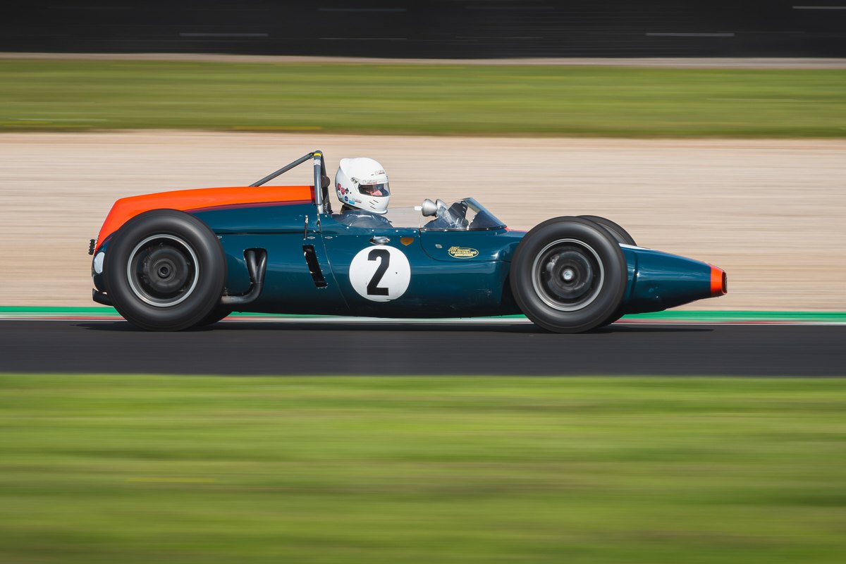 A classic open-wheel race car speeding around a circuit