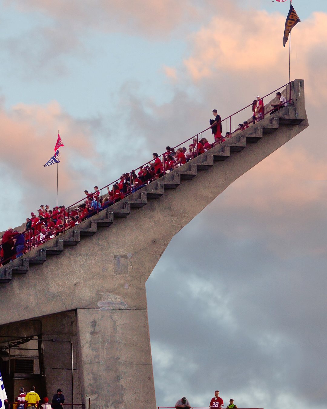 Football fans streaming down a stadium ramp on game day